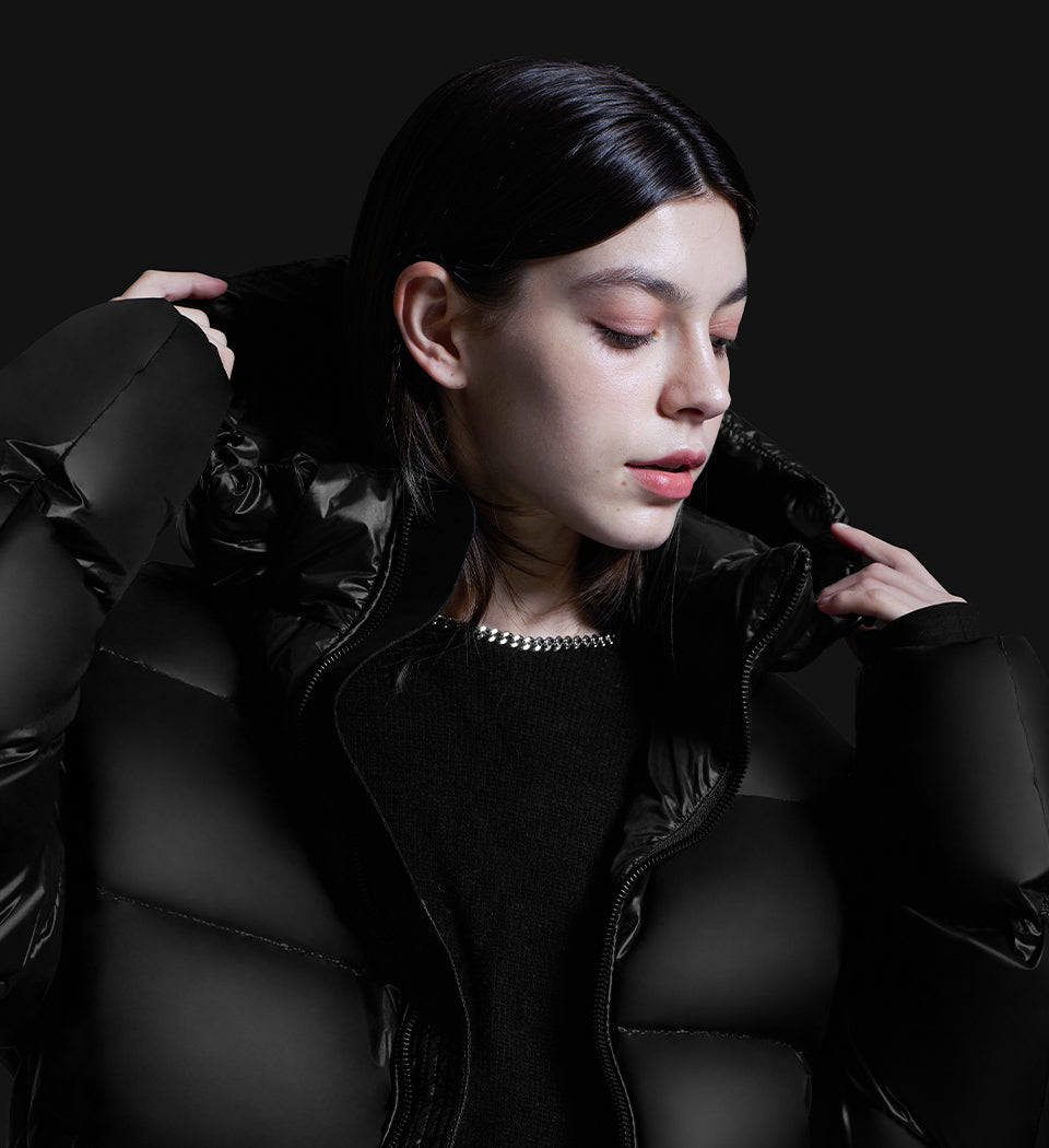 woman in fashionable close-up pose with black puffer jacket