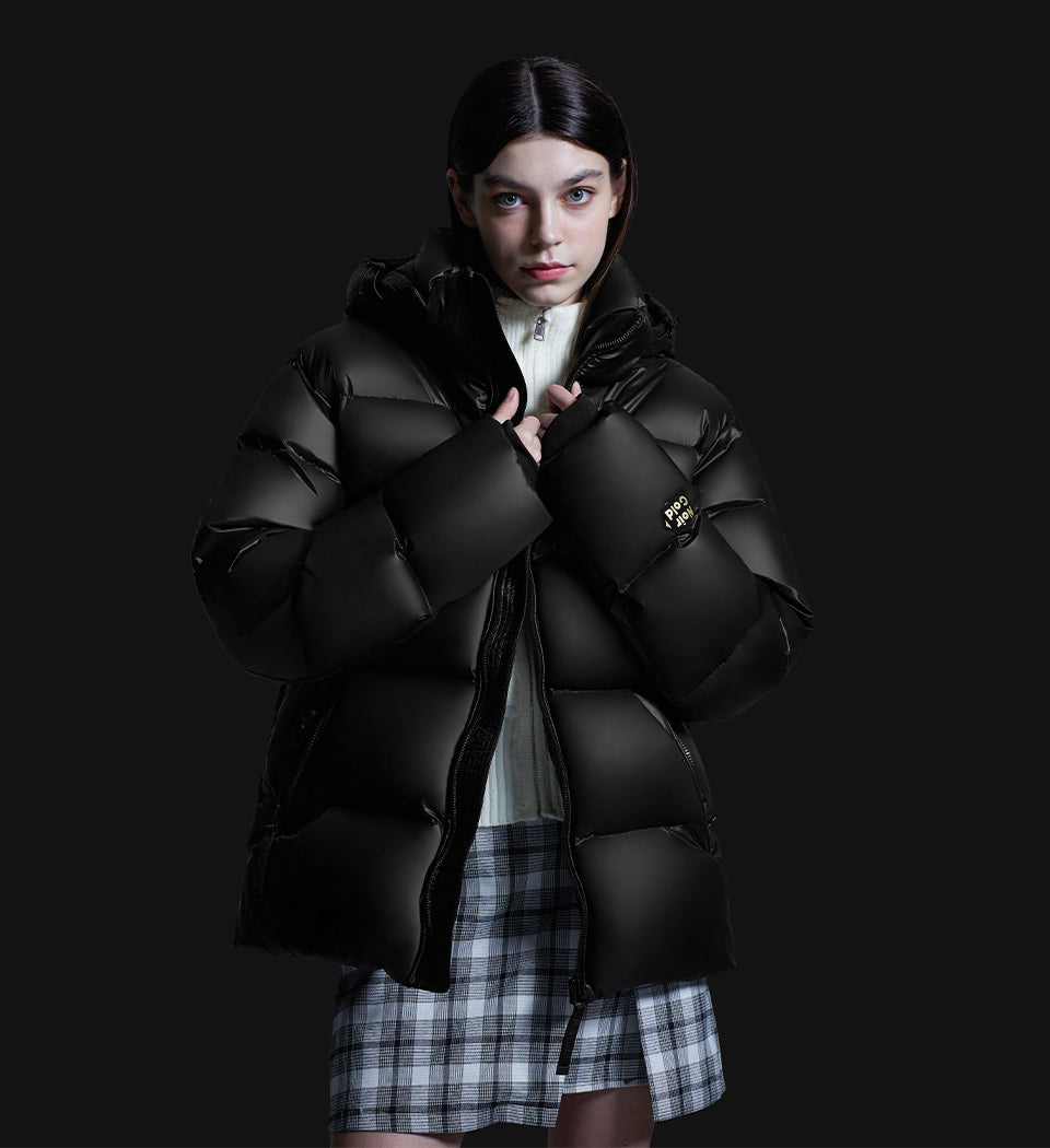 woman wearing winter puffer jacket over wool sweater and checkered skirt